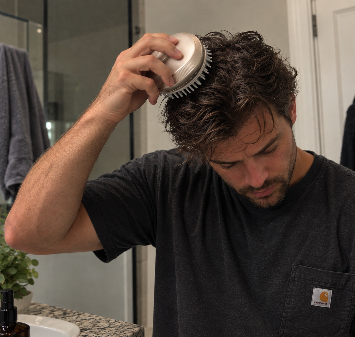 Woman using RootGlow scalp massage and hair care comb